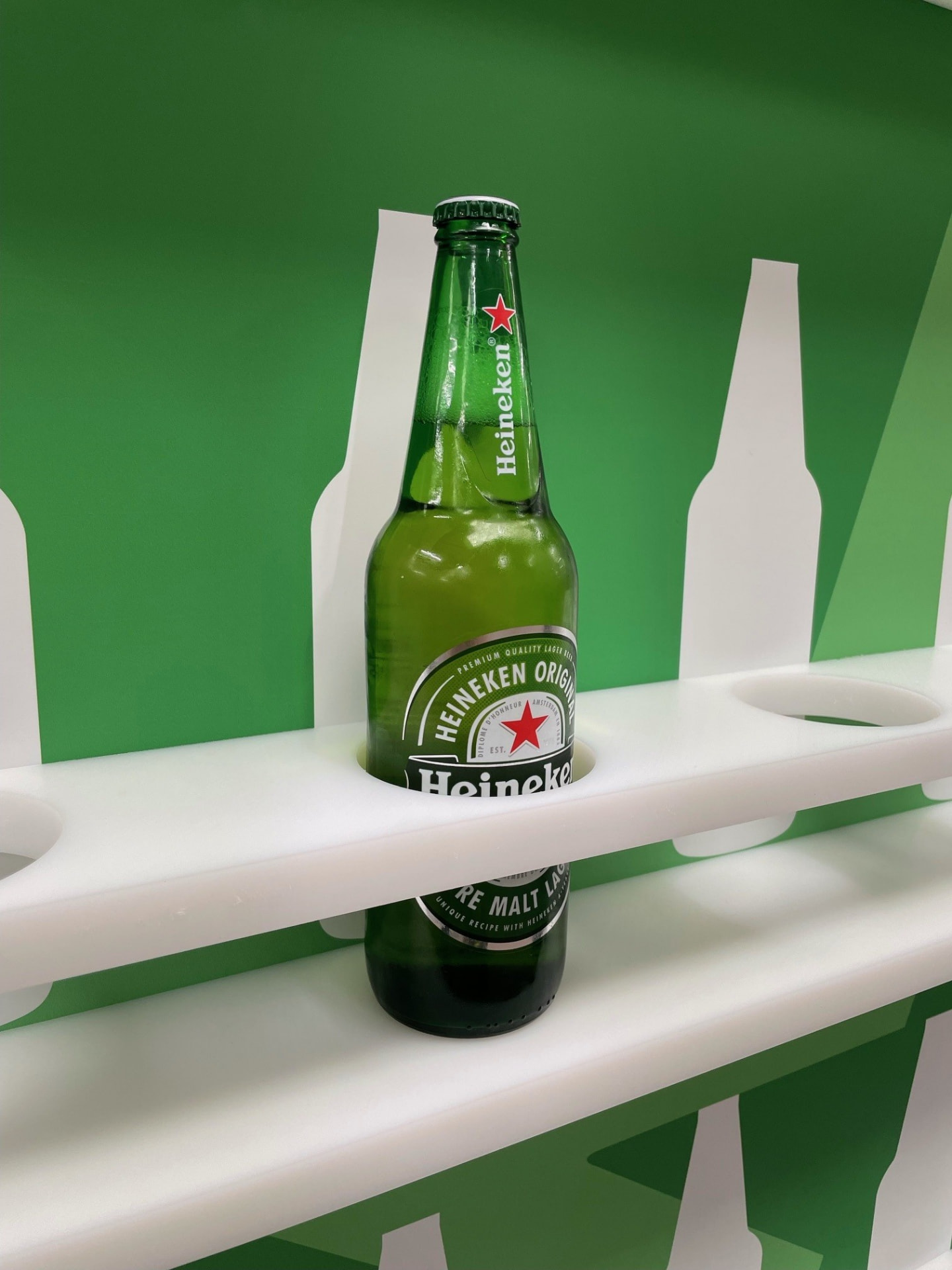 Heineken bottle retained in a CNC-machined white nest on a green shadow board
