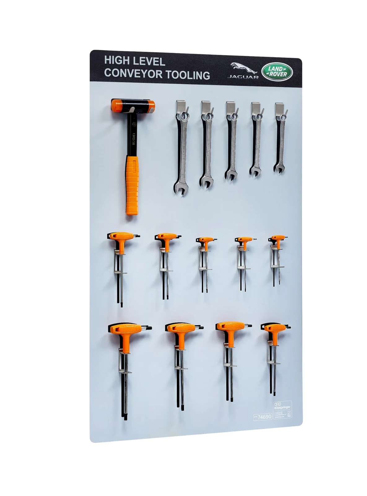 Jaguar Land Rover high-level conveyor tooling board holding a mallet, spanners and colour-coded hex keys