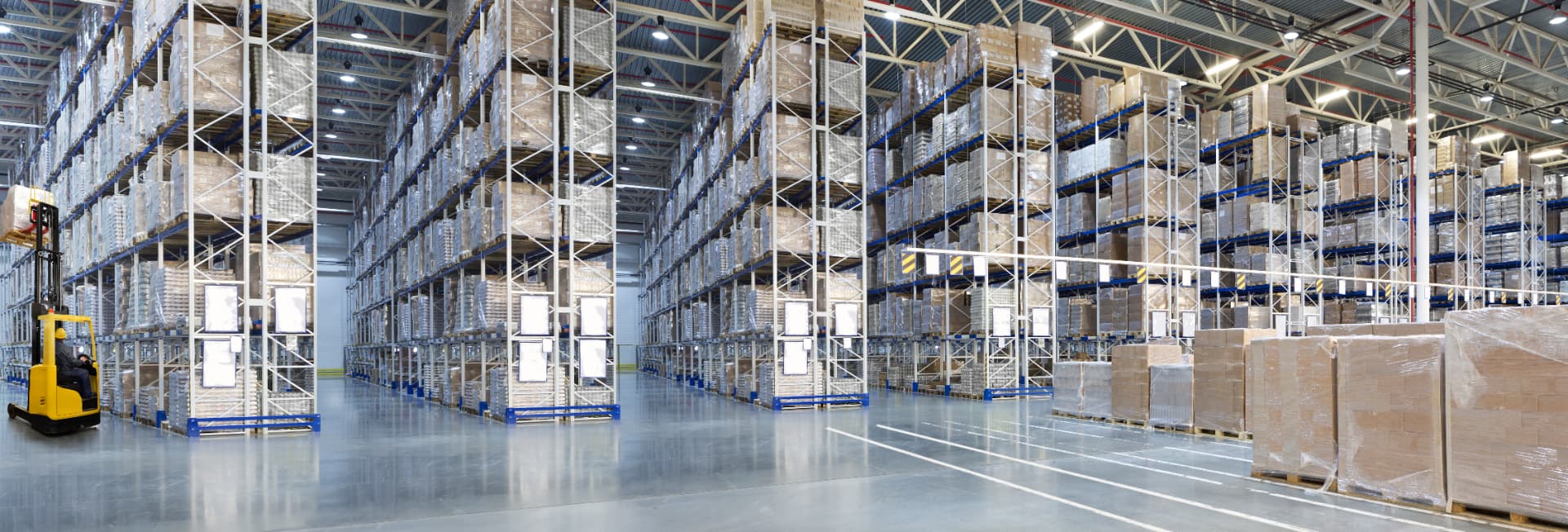 Large distribution warehouse with pallet racking and forklift operations