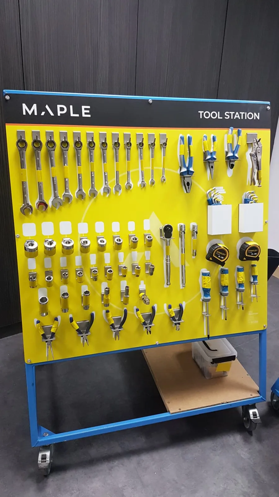Yellow Maple tool station on a mobile blue frame holding a full set of spanners and pliers