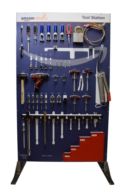 Floor-standing Amazon Robotics tool station on a steel frame with hammers, spanners and screwdrivers